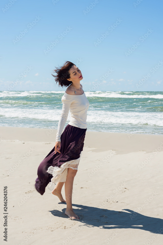 Beautiful brunette woman in dress by the sea Beautiful brunette woman in dress by the sea