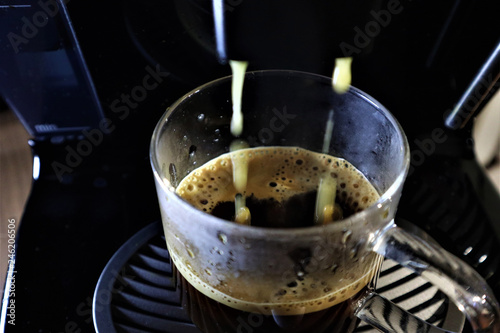 Close-up of espresso pouring from coffee machine.