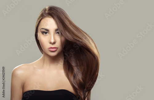 Beautiful brunette girl with long and straight brown hair . Shiny smooth and healthy well-groomed hair .