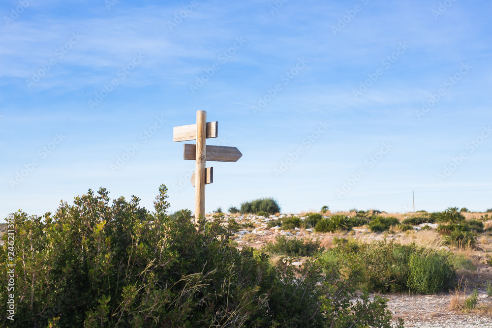 Direction sign with blank spaces for text on beautiful sky background Direction sign with blank spaces for text on beautiful sky background
