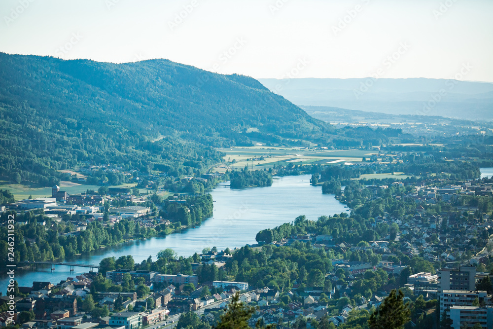 Panoramic top view of Drammen city, mountains in fog and valley with river, sunny weather. Norway