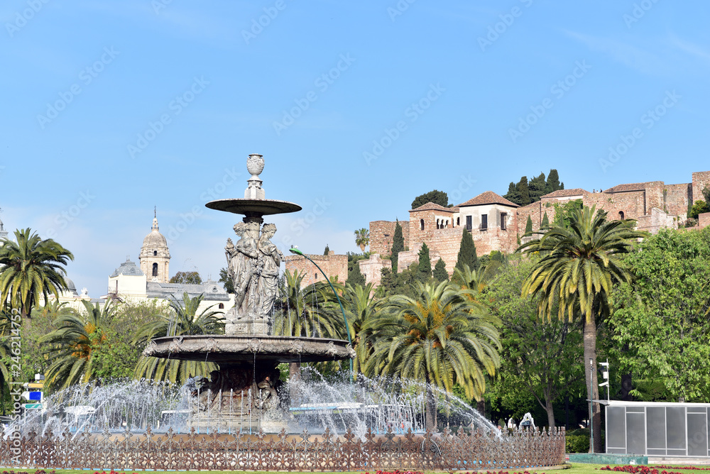Fountain with Alcazaba castle to the rear, Malaga, Costa del Sol, Malaga Province, Spain
