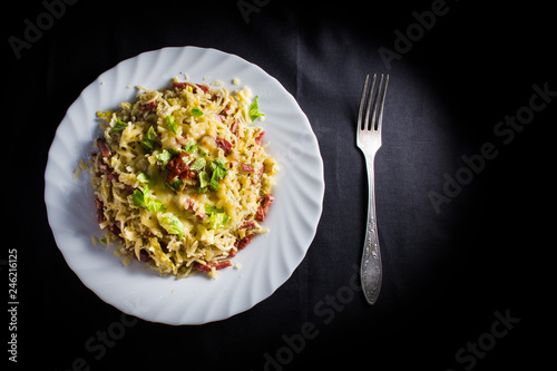 mac n cheese on white plate. Black Background. Isolated food