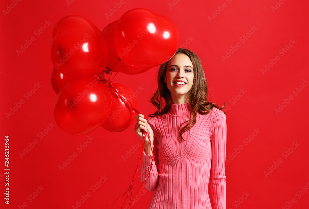 beautiful emotional girl in pink dress with red ballons on red background beautiful emotional girl in pink dress with red ballons on red background