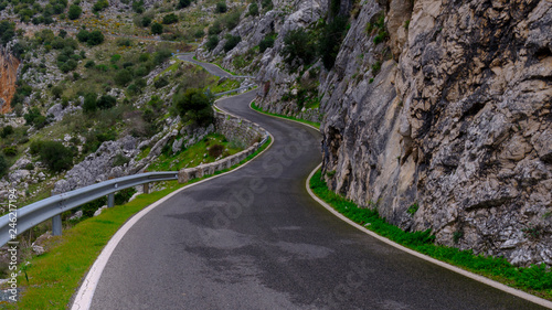 Twisting mountain road in the Sierra Grazalema near the Cueva del Hundidero and Montejaque, Spain photo