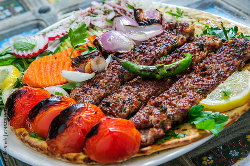 Plate of arabic kebab meat with grilled vegetables.