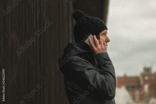 Worried woman talking on mobile phone on street © Bits and Splits