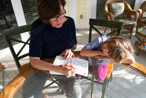 Grandmother and granddaughter doing a math puzzle