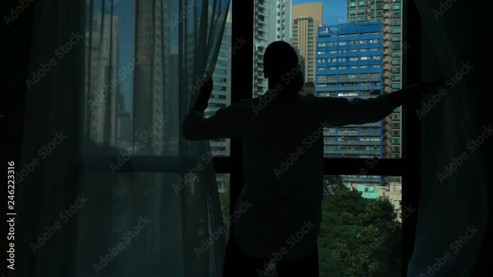 Woman unveil curtain and admire view from window at home, super slow motion Woman unveil curtain and admire view from window at home, super slow motion
