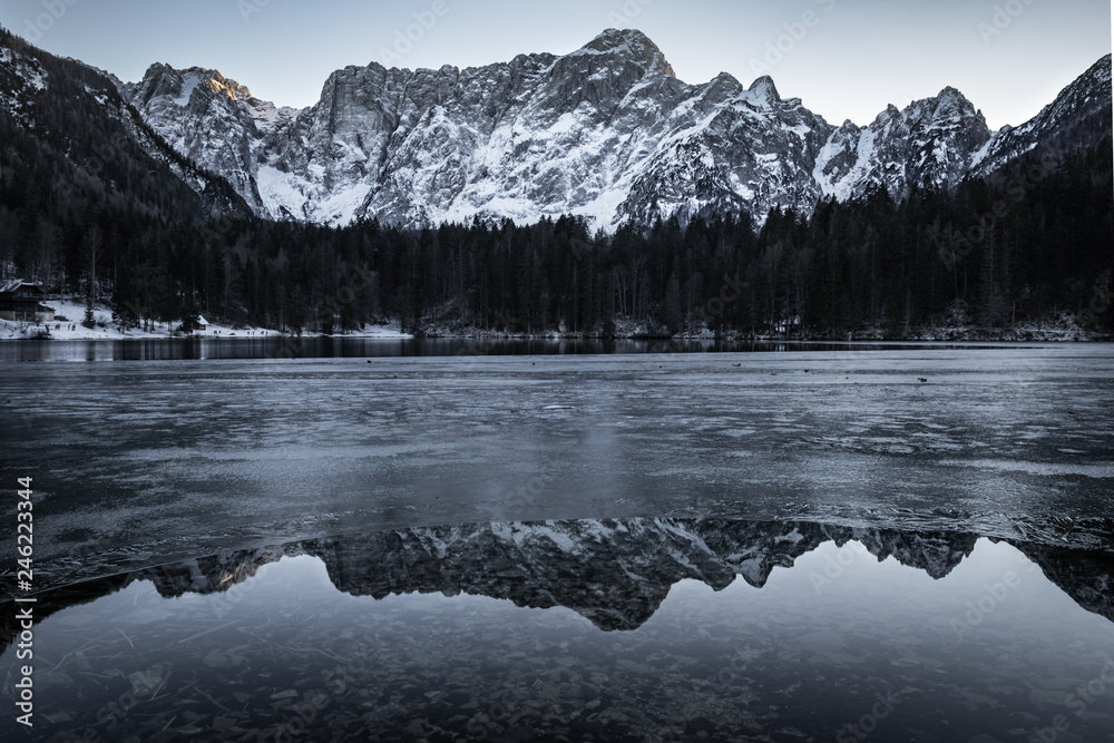 beautiful frozen fusine lakes in julian alps, italy