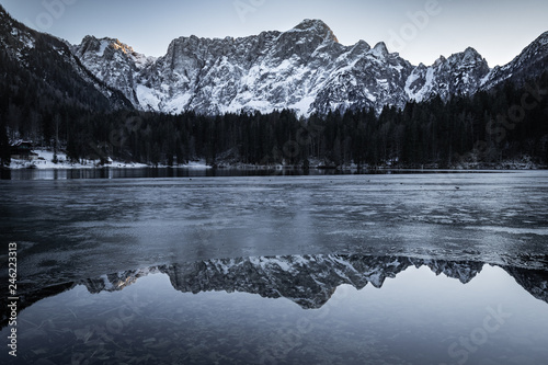 beautiful frozen fusine lakes in julian alps, italy