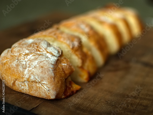 Ciabatta. homemade italian ciabatta bread top view. Bread with cheese. Sliced fresh bread on a wooden tray.