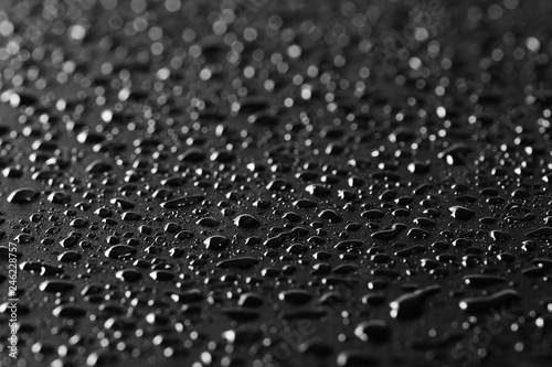 Water droplets on black background and texture, macro and side view