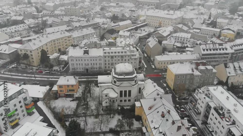 Drone shot over looking the city of Sankt P√∂lten, in Austria, the city is all covered by snow, during a foggy day. photo