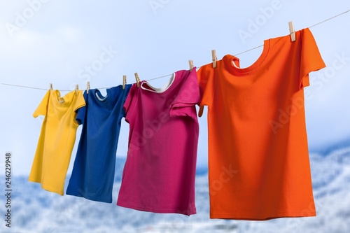 Wash clothes on a rope with clothespins on  background