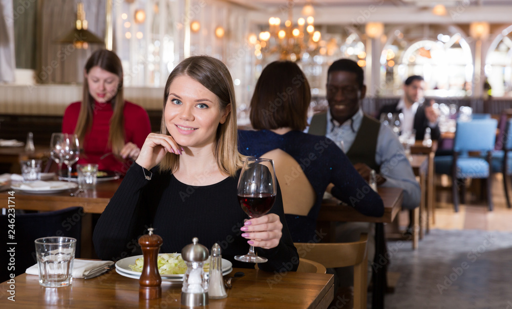 Woman enjoying dinner alone in restaurant