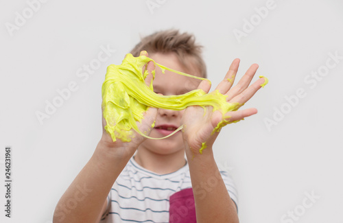 child playing hand made toy called slime. selective focus
