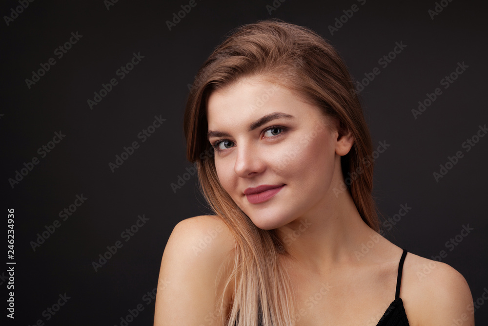 Young beautiful woman against dark background Young beautiful woman against dark background