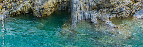 Areal view  of pure turquoise river water and white rocks. Natural background with space for text