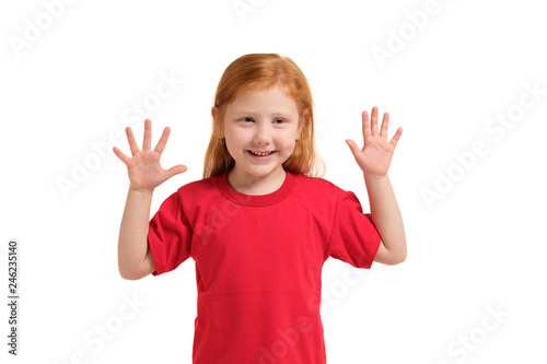 Little girl smiling with his arms up. 5 years old girl surprised with smile and hands near her hands