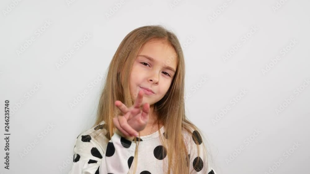 Cute young girl looks intently at the camera and shows that she is watching you. Cute young girl looks intently at the camera and shows that she is watching you.