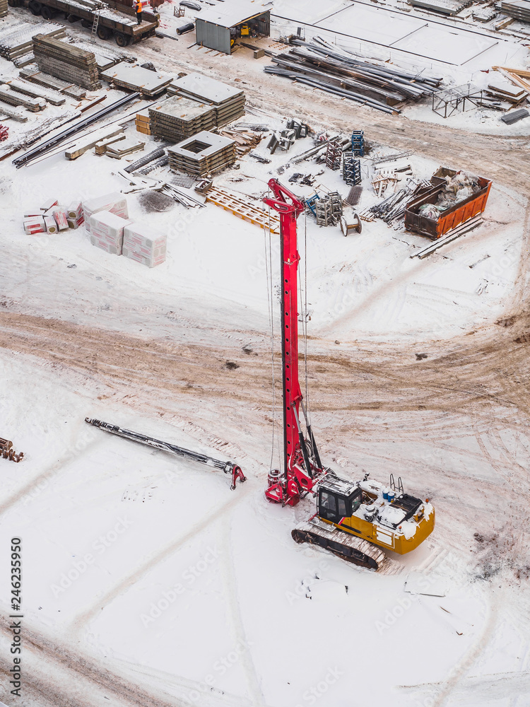 Crane and building construction. Winter air view