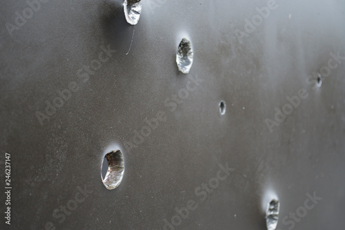 Armor shot through with bullets. Bullet holes