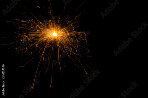 Bengal fire. New year sparkler candle on black background