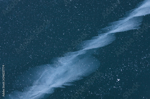 Cracks in ice of Baikal lake. Winter texture