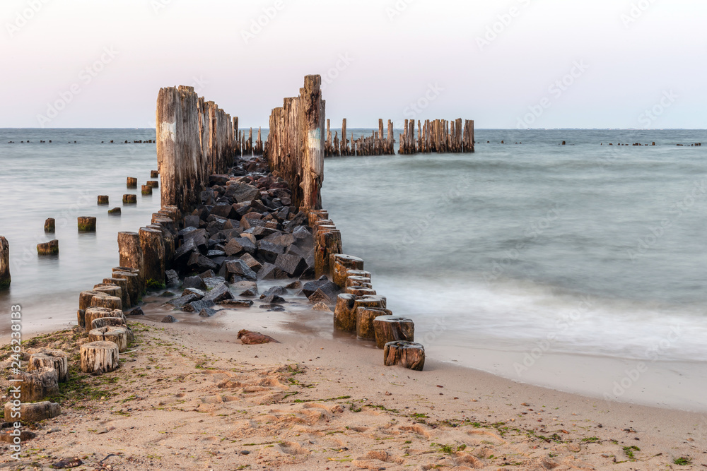 Wooden breakwaters on the sea shore