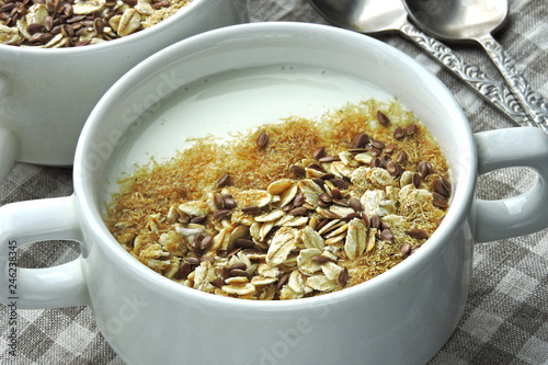 Healthy breakfast with white yogurt or kefir, bran, oatmeal and flaxseeds. Eco food. Superfoods