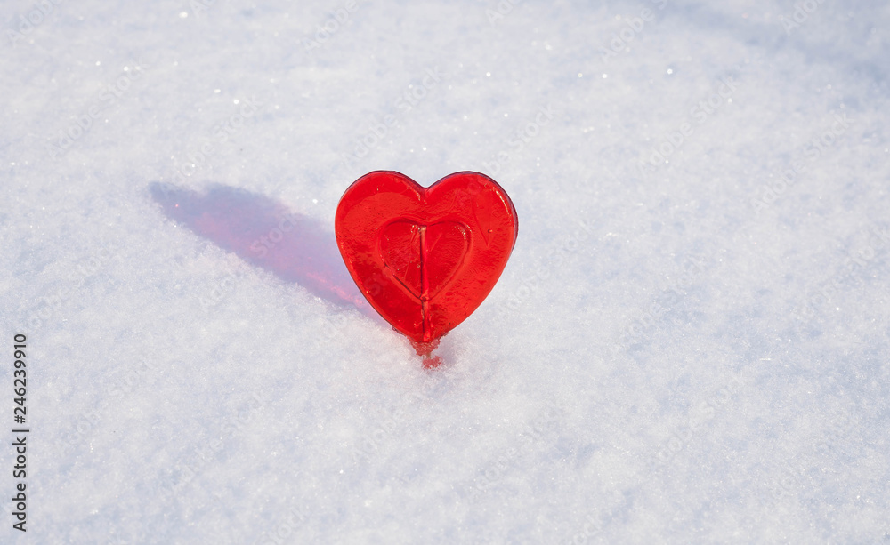 Sweet One Valentines heart made of sugar with reflection effect on snow