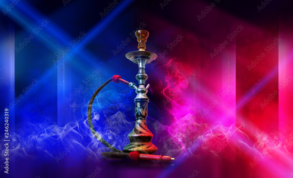 Smoking hookah on the background of an empty room. Multicolored neon light.  Searchlight, laser blue and pink rays, smoke. Stock Photo | Adobe Stock