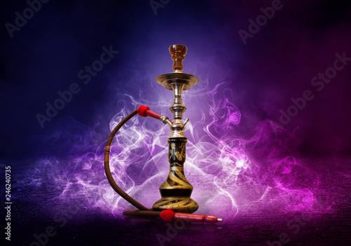 Hookah smoking on a background of abstract futuristic background, neon light, smoke.