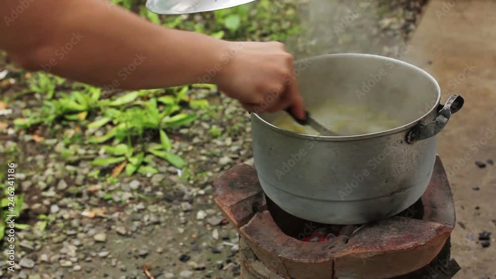 Cooking Food over Thai traditional charcoal burning old stove, Thai traditional cooking, Thai lifestyle. Cooking Food over Thai traditional charcoal burning old stove, Thai traditional cooking, Thai lifestyle.