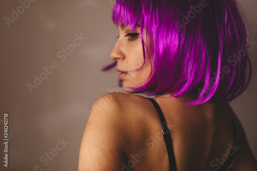 Beautiful back of naked woman wear pink wig. Portrait of nude girl. Sexy young lady in black underwear. Hot woman wear lingerie.
