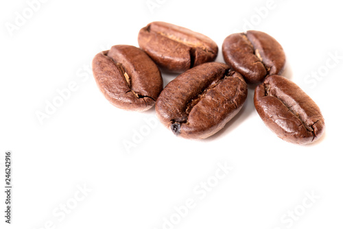 Macro of coffee beans on white background. Selective focus