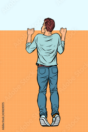 young man looks over the fence