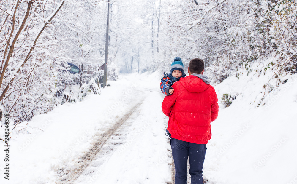 Son and father at winter day