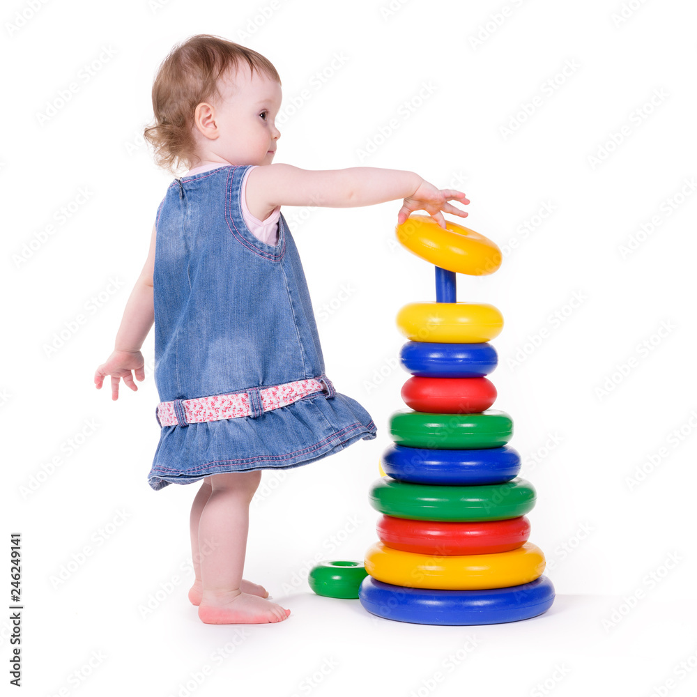 Small child plays with teaching colored toys. Isolated over white background Small child plays with teaching colored toys. Isolated over white background