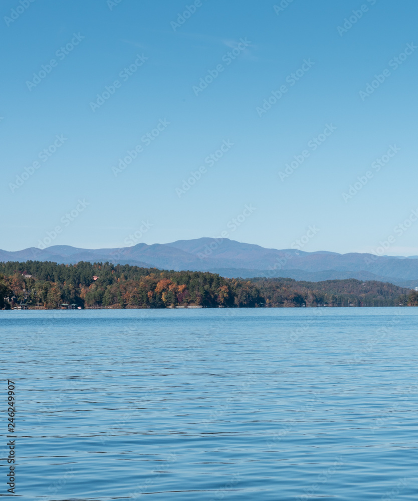Calm lake with Mountains in the distance.  Lake during the fall season.