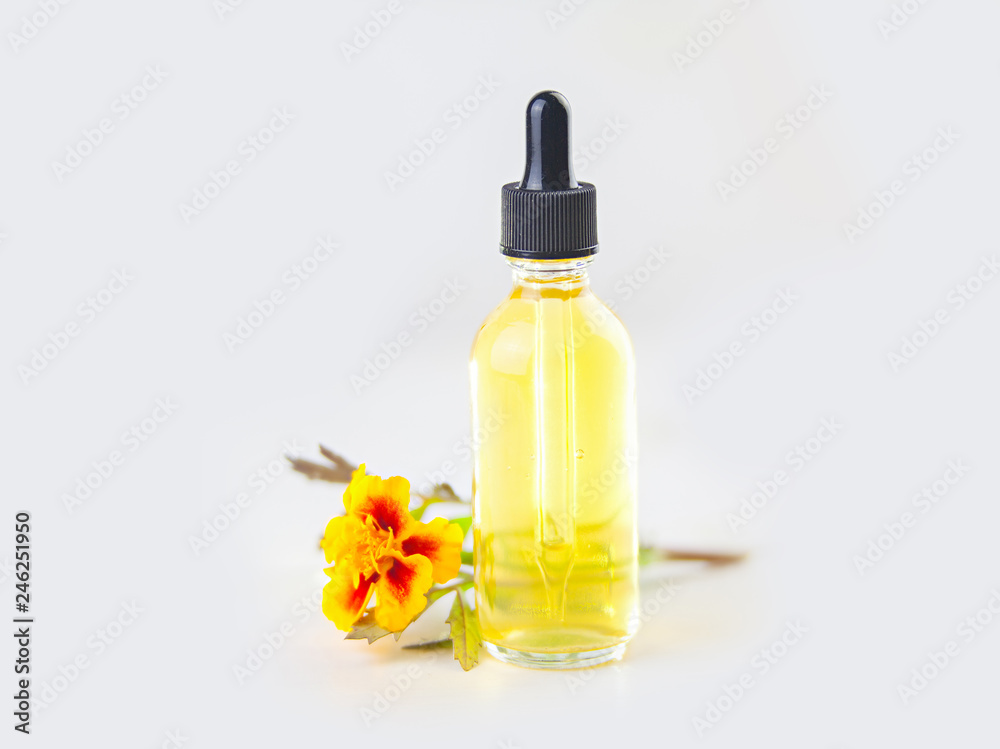 marigold essential oil in  beautiful bottle on White background