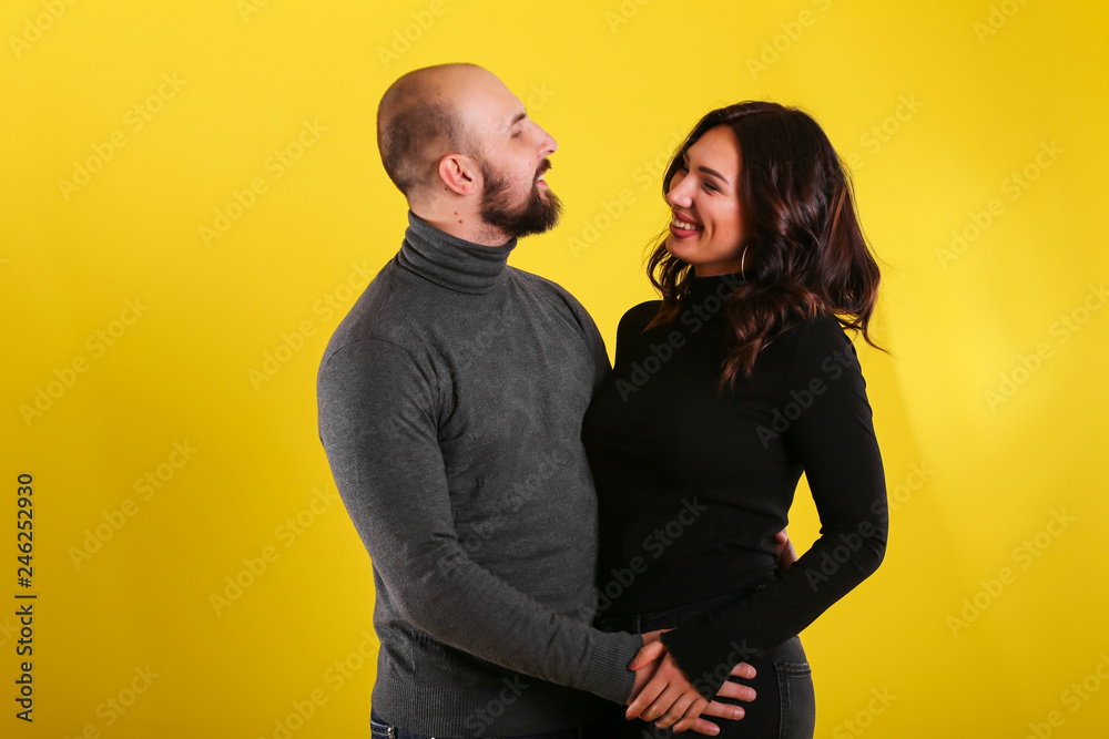 young sexy couple models in hugs in love smile and happy on yellow background , isolated on yellow , love ,couple young sexy couple models in hugs in love smile and happy on yellow background , isolated on yellow , love ,couple