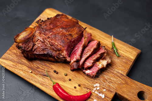 delicious steak, seasonings, a delicious piece of meat, cooked dinner on a concrete background