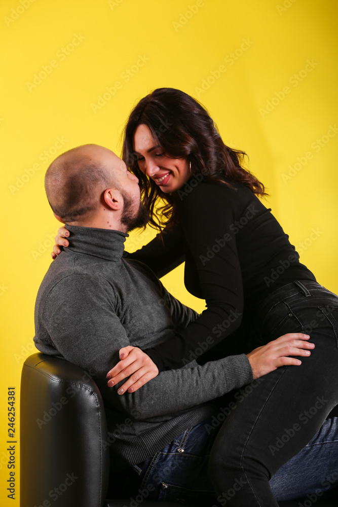 young sexy couple models in hugs in love smile and happy on yellow background , isolated on yellow , love ,couple young sexy couple models in hugs in love smile and happy on yellow background , isolated on yellow , love ,couple