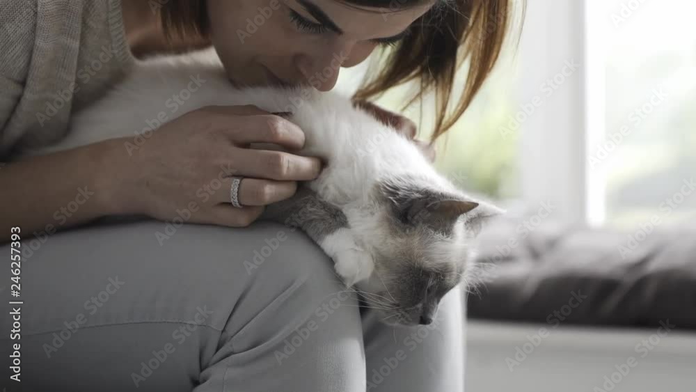 Woman hugging and cuddling a cat on her lap Woman hugging and cuddling a cat on her lap