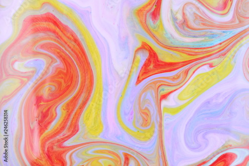 Fluid art from different colors. Multicolored background from paints on liquid. Bright pattern on liquid. Colored paint stains in style of pop art
