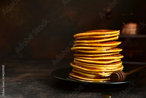 Homemade pancakes with honey or maple syrup.