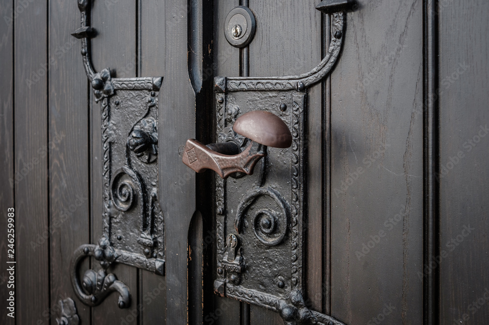wrought metal door handle closeup - church entrance wrought metal door handle closeup - church entrance