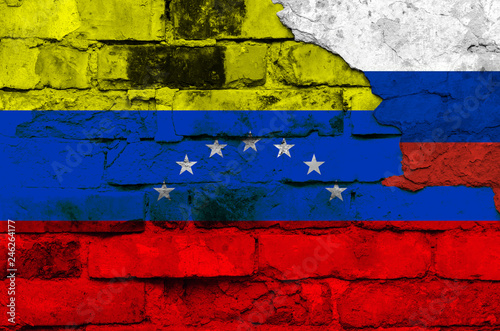 Flag of Venezuela and Russia on the background of a brick wall with broken plaster © Алексей Еремеев